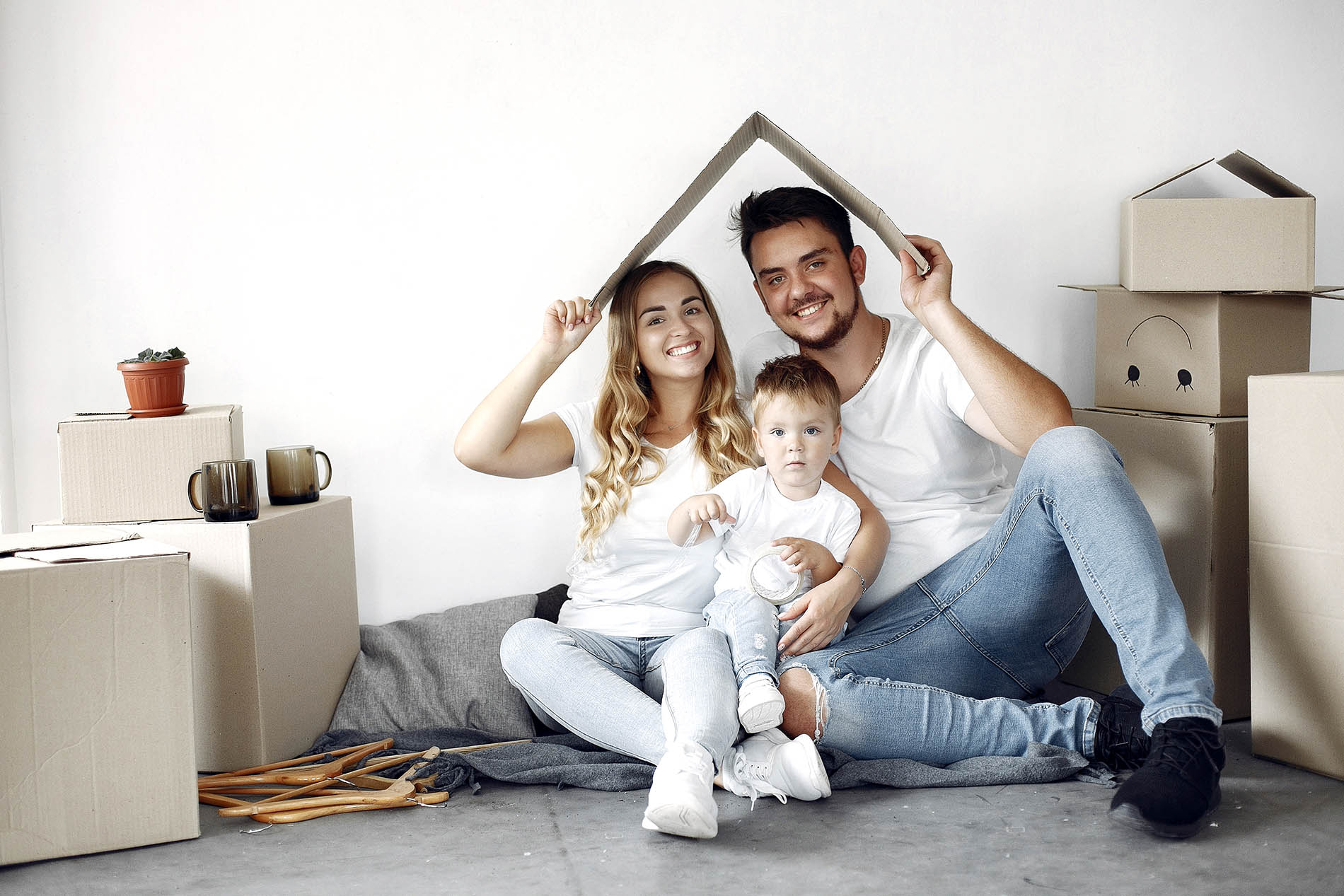 Family sitting together surrounded by moving boxes